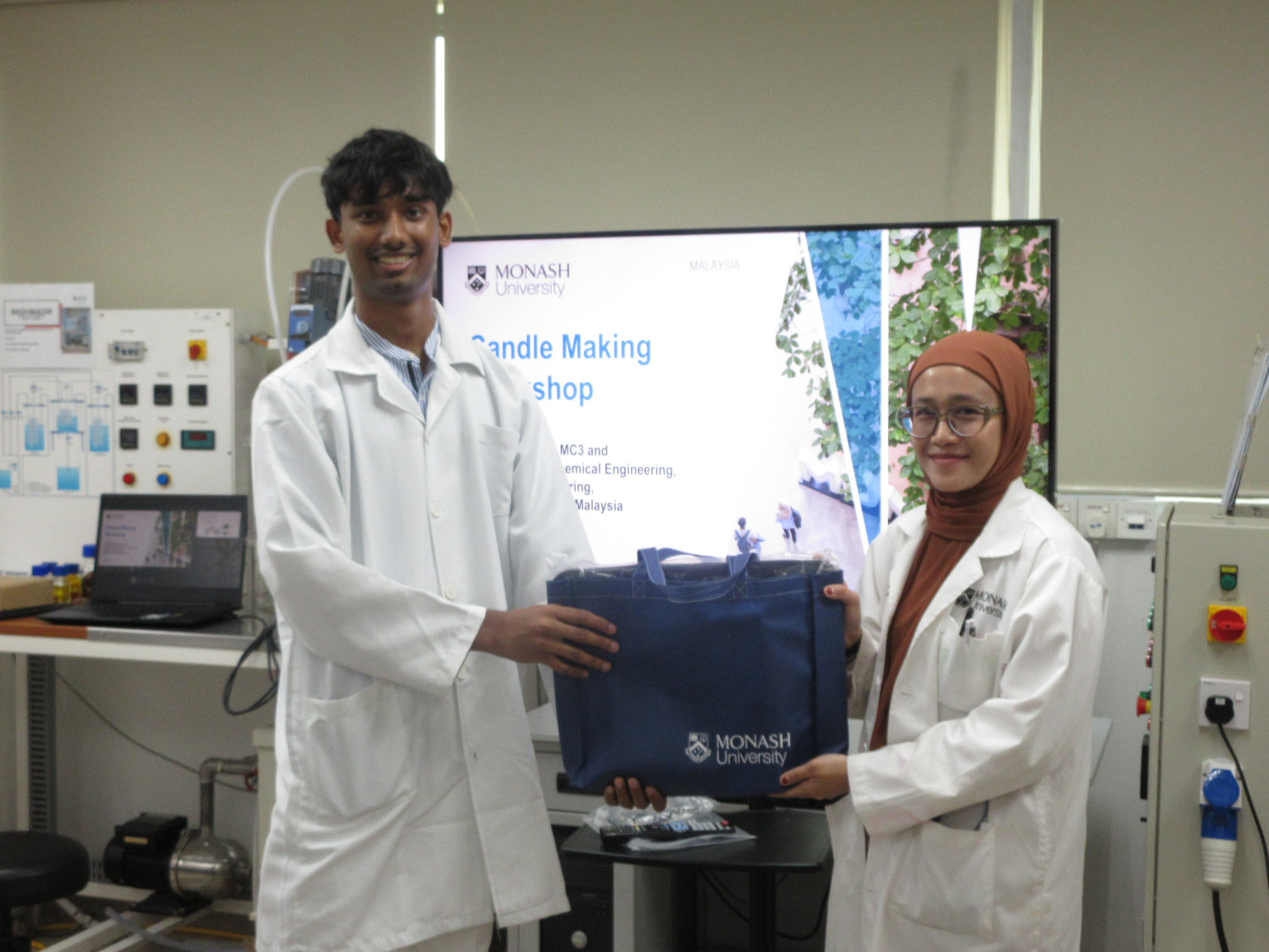 Aloka presenting a token of appreciation during the candle-making workshop